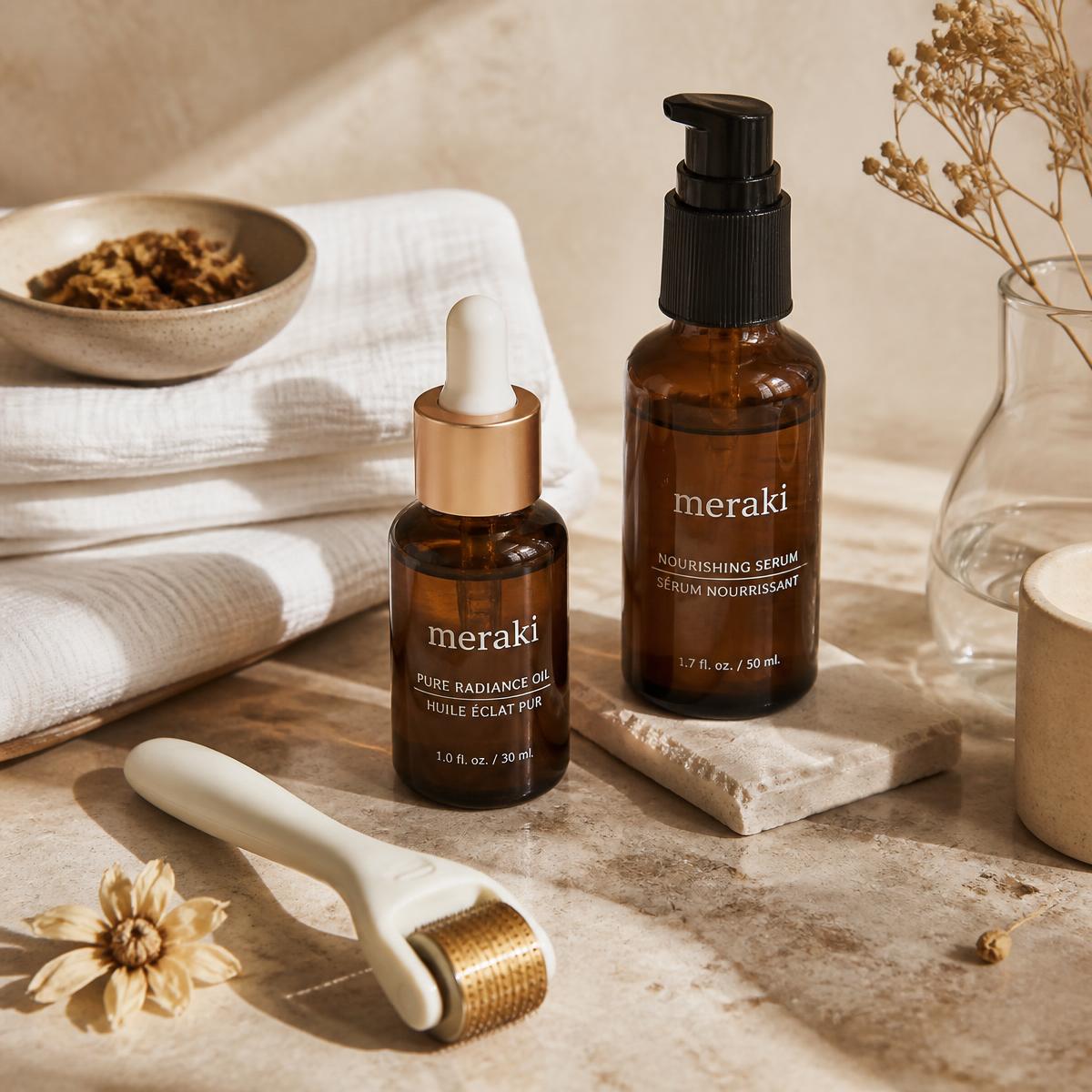 Serums, linen towels and treatment tools on a travertine surface